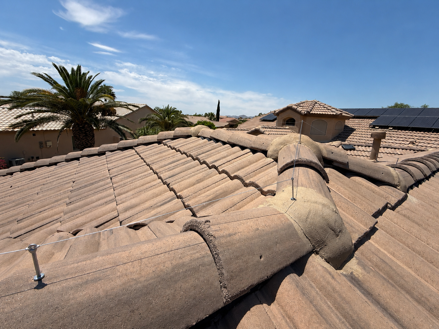 Ridgeline wire installed across tile roof intersections