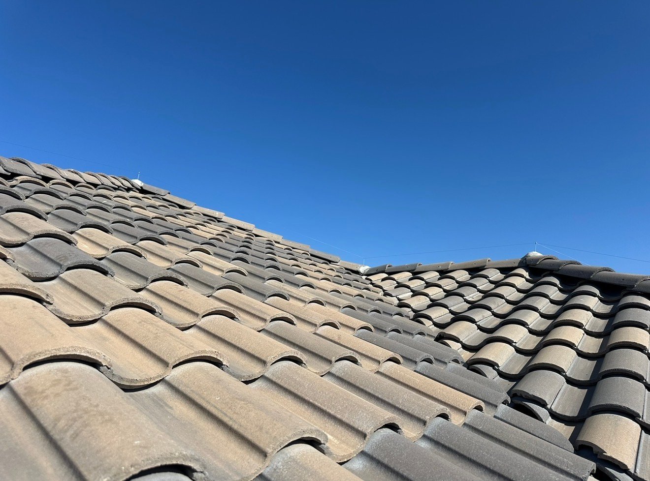 Ridgeline wire posts visible along an Arizona tile roof