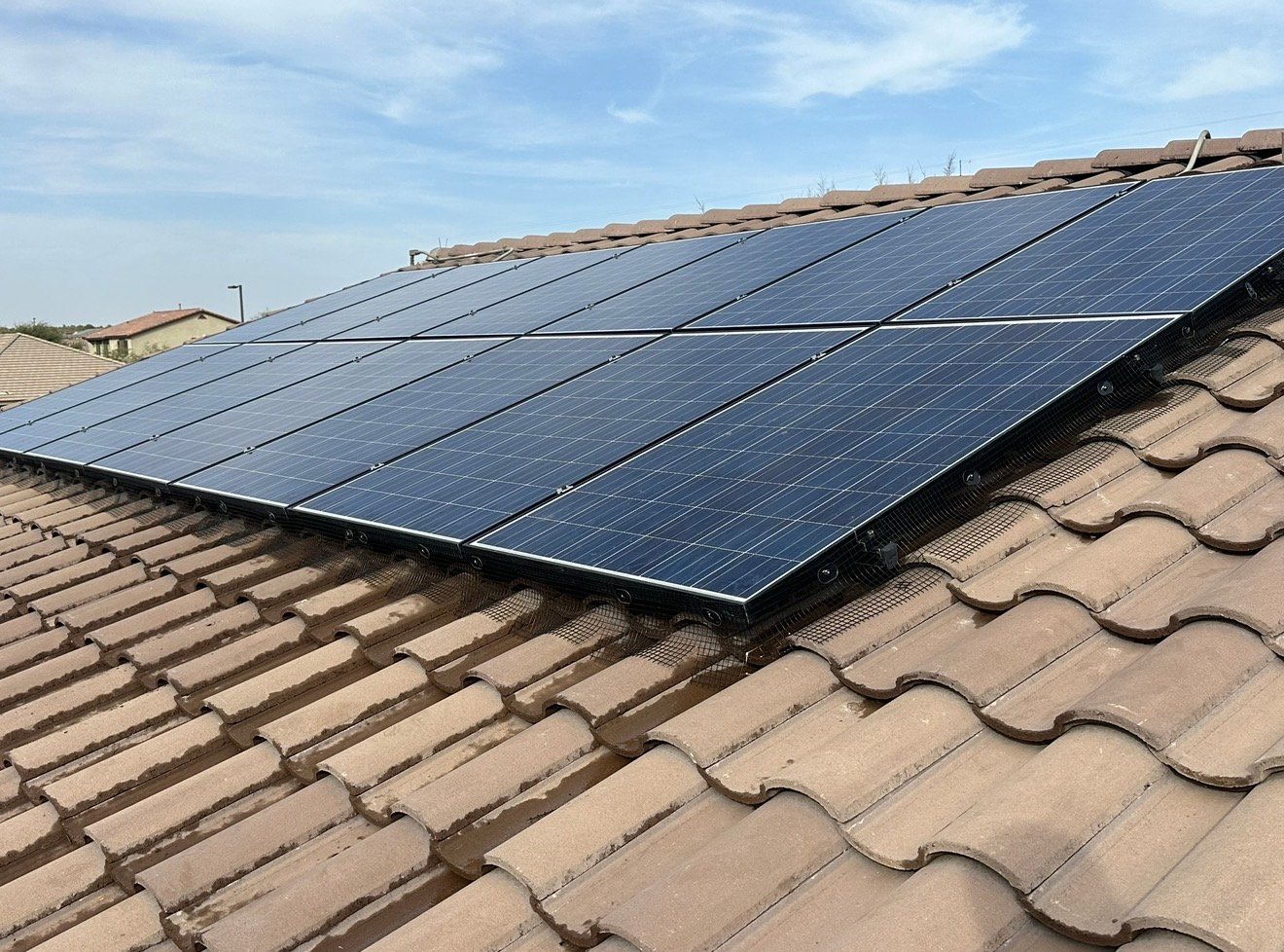 Finished pigeon mesh installed around solar panels on an Arizona tile roof