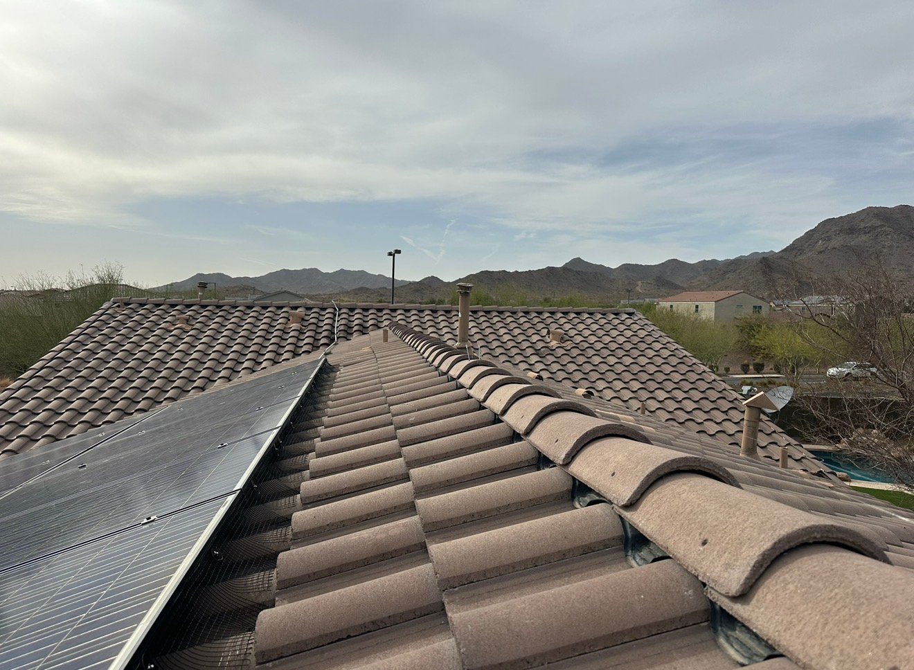 Wide roof view showing solar mesh installed alongside tile roof panels